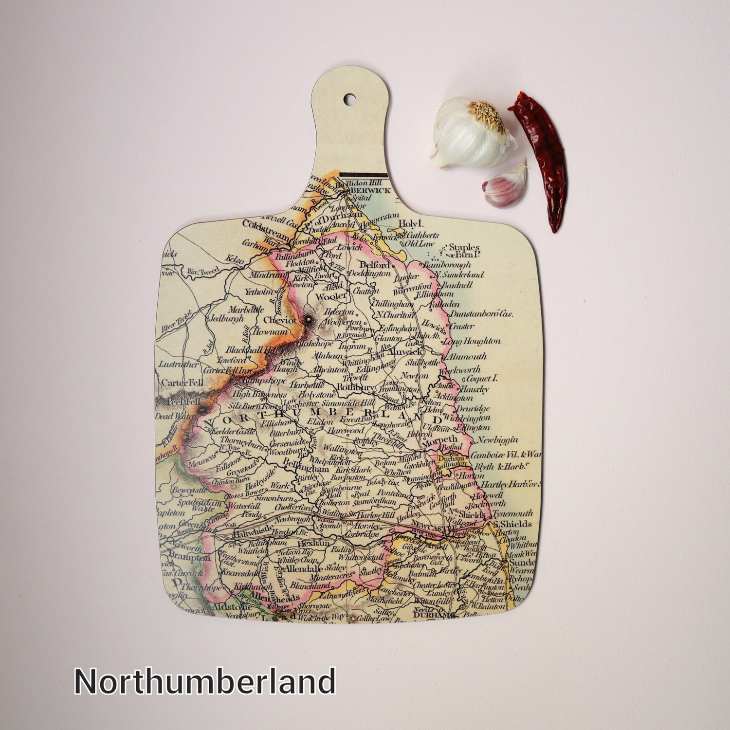 A large chopping board with a vintage Northumberland map on.  